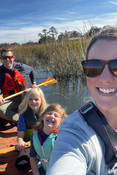 Eric Warren with wife and kids on kayak